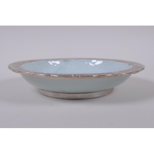 123 - A celadon and silver ground dish with lobed rim and raised dragon decoration, Chinese Qianlong seal ... 