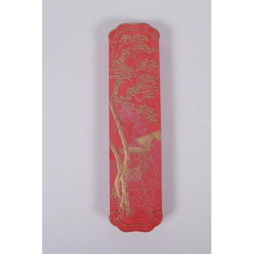 128 - A Chinese red ground ink stone with gilt relief landscape and dragon decoration, in a fitted box, 7 ... 