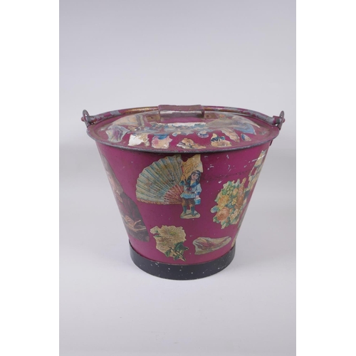 13 - An antique painted galvanised bucket and cover, with decoupage decoration, 28cm x 35cm diameter