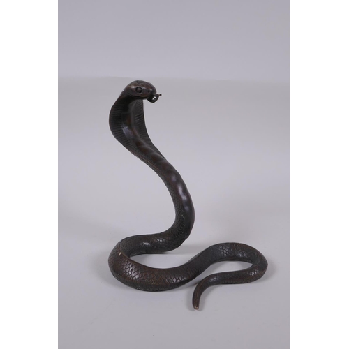 132 - A filled bronze figure of a cobra, 18cm high