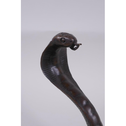 132 - A filled bronze figure of a cobra, 18cm high