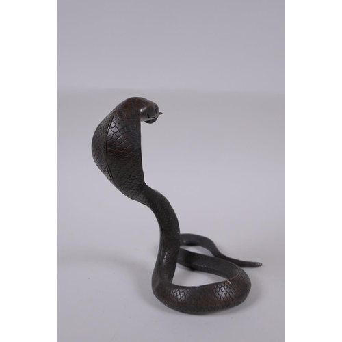 132 - A filled bronze figure of a cobra, 18cm high