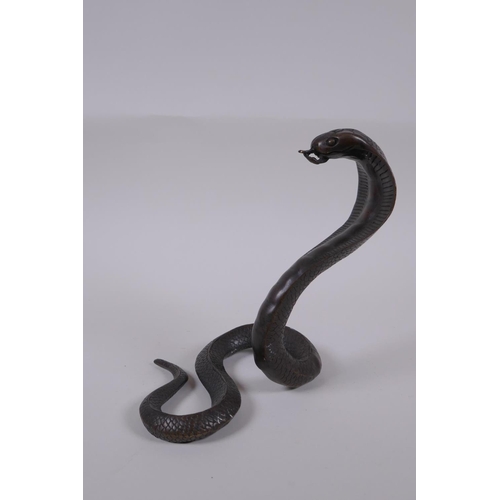 132 - A filled bronze figure of a cobra, 18cm high