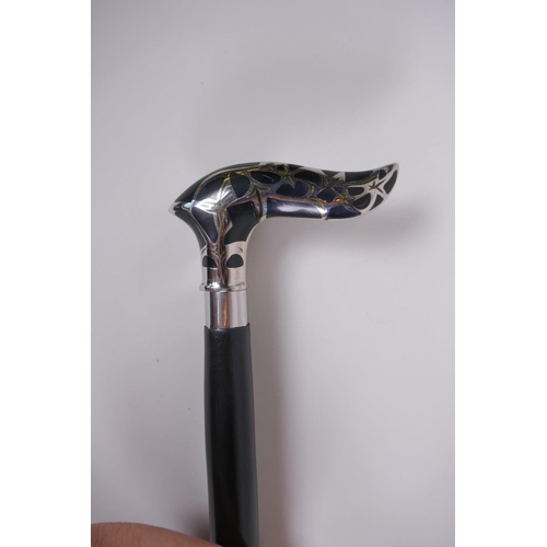 134 - An ebonised wood walking stick with a chromed metal and enamel Art Nouveau style handle, 92cm long