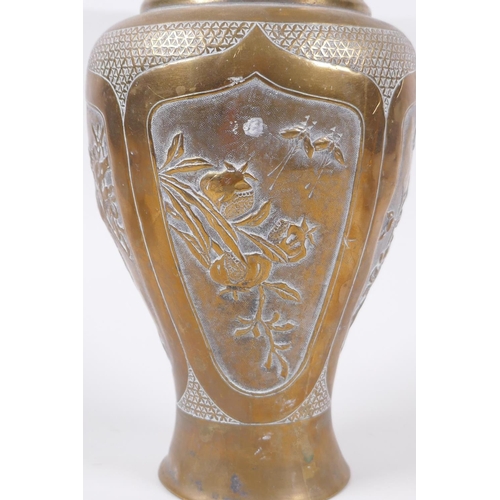 135 - A Japanese Meiji bronze two handled vase with decorative repousse panels depicting birds and insects... 