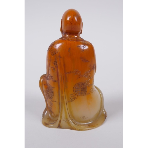 137 - A Chinese faux amber soapstone figure/seal in the form of Lo-han, 12cm high