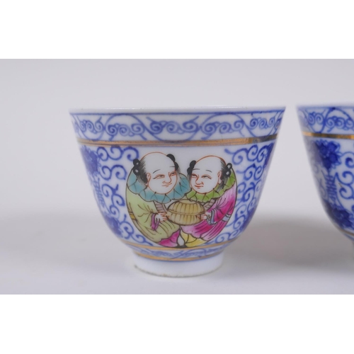 139 - A pair of Chinese blue and white porcelain tea bowls with polychrome enamels panels depicting two fi... 