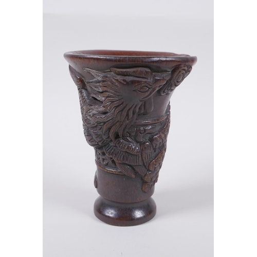 141 - A Chinese faux horn libation cup with phoenix decoration, seal mark to base, 13.5cm high