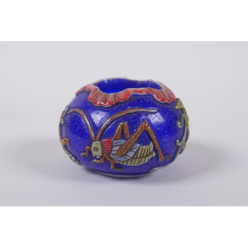 143 - A Chinese blue Peking glass bird feeder with raised and enamelled insect and gourd decoration, mark ... 