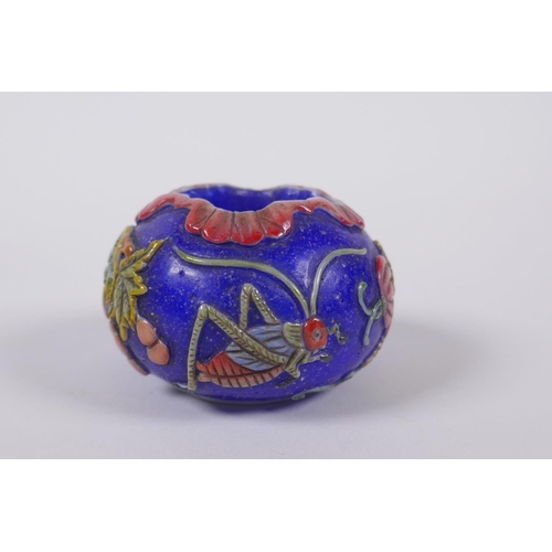 143 - A Chinese blue Peking glass bird feeder with raised and enamelled insect and gourd decoration, mark ... 