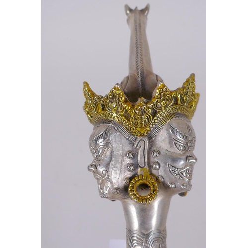 153 - A Tibetan white metal kartika, the handle decorated with wrathful deity masks, 27cm