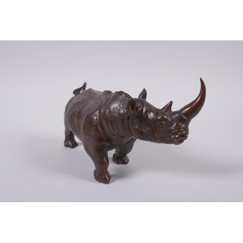 155 - A filled bronze figure of a rhinoceros, 22cm long 