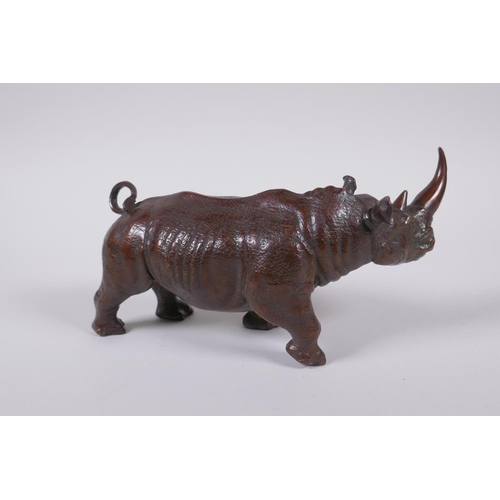 155 - A filled bronze figure of a rhinoceros, 22cm long 