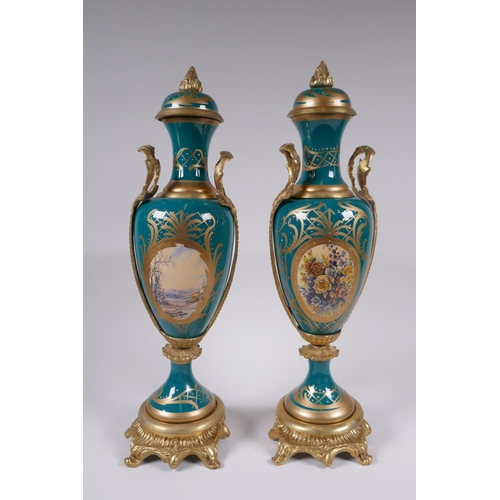 162 - A pair of Sevres style porcelain urns and covers with ormolu mounts and handles, with decorative flo... 