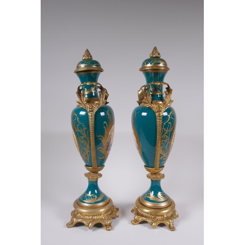 162 - A pair of Sevres style porcelain urns and covers with ormolu mounts and handles, with decorative flo... 