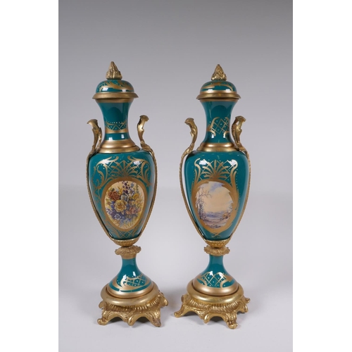 162 - A pair of Sevres style porcelain urns and covers with ormolu mounts and handles, with decorative flo... 