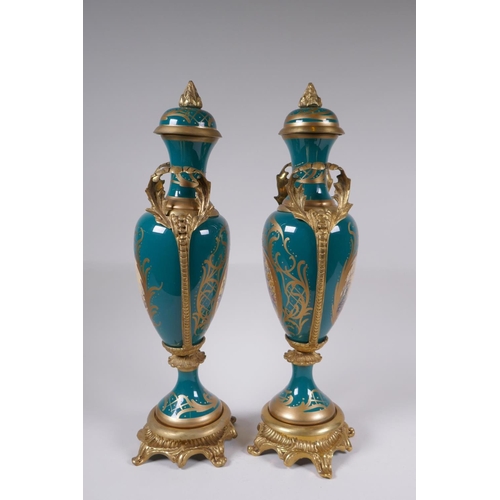 162 - A pair of Sevres style porcelain urns and covers with ormolu mounts and handles, with decorative flo... 