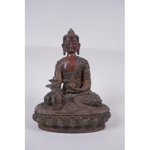 169 - A Tibetan bronzed metal Buddha with the remnants of gilt and copper patina, impressed double vajra m... 