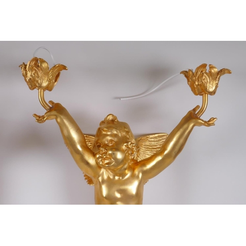 17 - A pair of ormolu two branch wall sconces in the form of a winged putti, 70cm x 30cm wide