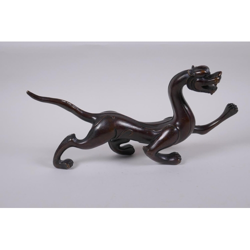 171 - A Chinese stylised bronze figure of a dragon, 32cm long