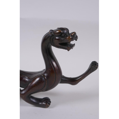 171 - A Chinese stylised bronze figure of a dragon, 32cm long