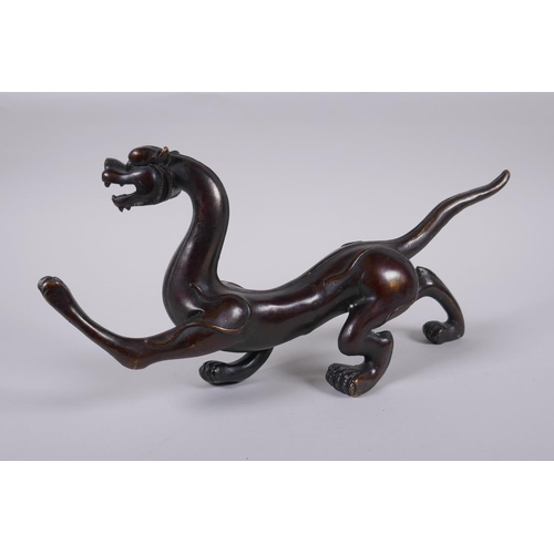 171 - A Chinese stylised bronze figure of a dragon, 32cm long