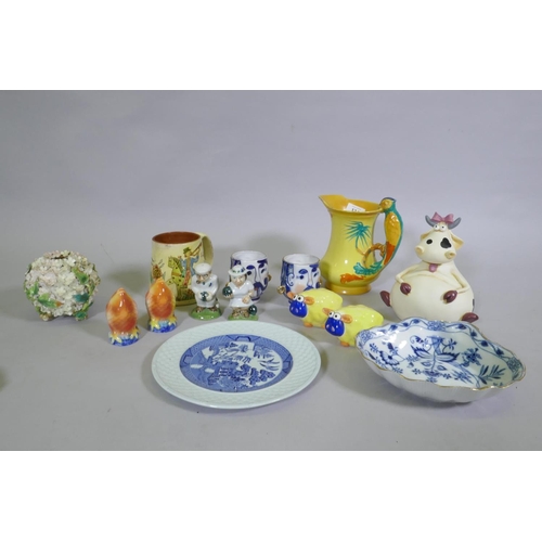 174 - Decorative pottery, novelty salt and pepper pots, Chiari cow savings bank, Burleighware parrot handl... 