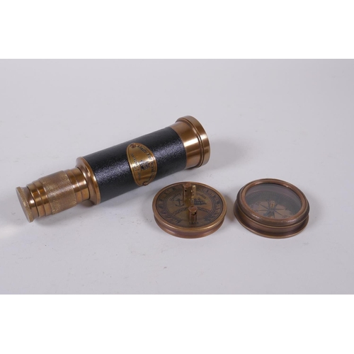 176 - A reproduction brass sundial compass and a brass and leatherette miniature telescope, 13cm long