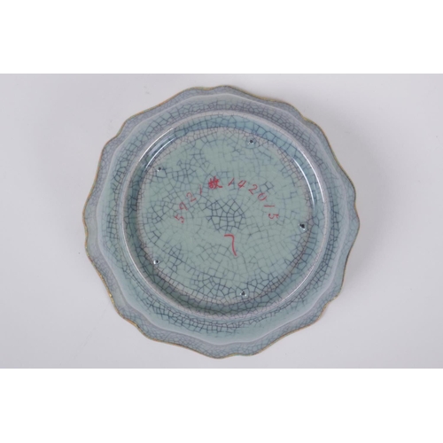 39 - A Chinese celadon Ge-ware dish of lobed form with a gilt metal rim and chased character marks to bow... 