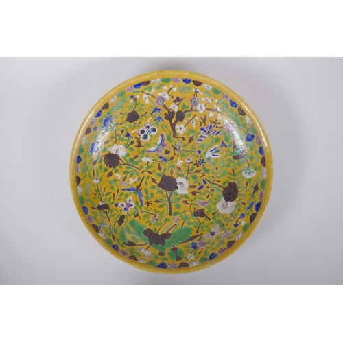 43 - A Chinese late C19th Sancai glazed porcelain charger with incised butterfly and floral decoration, X... 