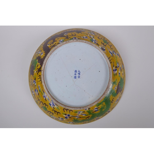 43 - A Chinese late C19th Sancai glazed porcelain charger with incised butterfly and floral decoration, X... 