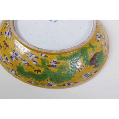 43 - A Chinese late C19th Sancai glazed porcelain charger with incised butterfly and floral decoration, X... 