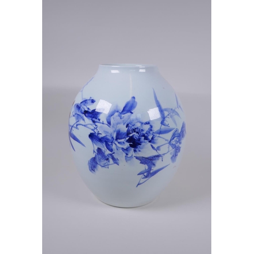 48 - A Japanese Meiji period blue and white porcelain vase decorated with a shrub in bloom, character ins... 