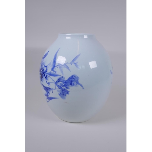 48 - A Japanese Meiji period blue and white porcelain vase decorated with a shrub in bloom, character ins... 