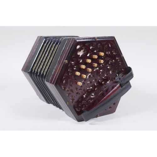 5 - A late C19th/early C20th twenty-one key hexagonal concertina by Lachenal & Co, London, pierced e... 