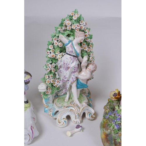 50 - Three early English porcelain figures to include a Chelsea brocage figure of a woman and child, a Bo... 