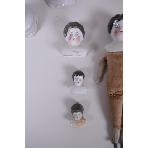 51 - A collection of antique continental porcelain doll heads and appendages, together with three Contine... 