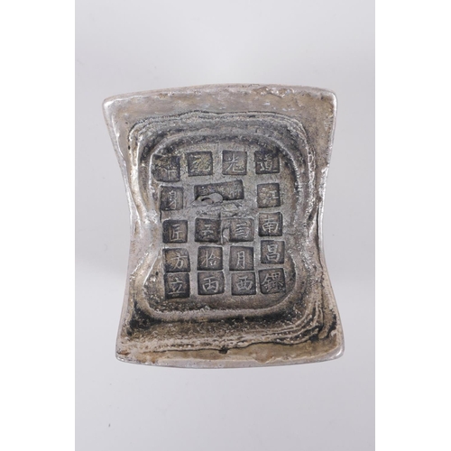 55 - A Chinese white metal ingot/trade token, with character mark stamps to top, 8cm x 10cm