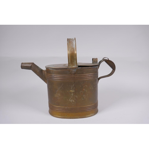 59 - An antique brass watering can, 25cm high x 32cm long