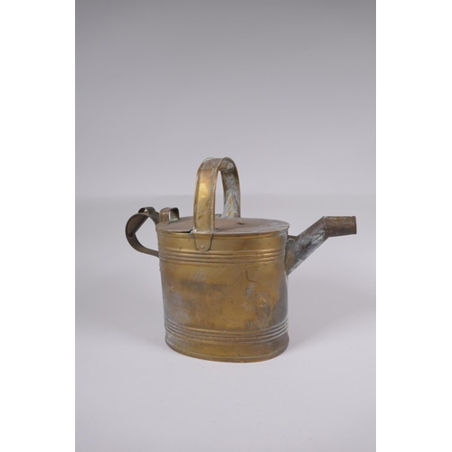 59 - An antique brass watering can, 25cm high x 32cm long