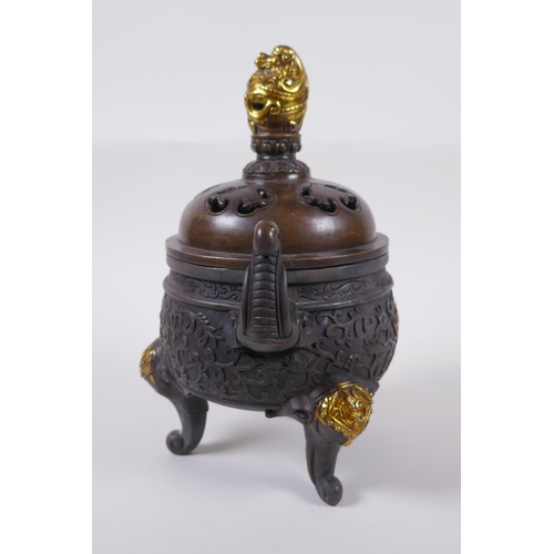 60 - A Chinese bronze two handled censer and cover raised on tripod elephant head feet, with dragon knop,... 