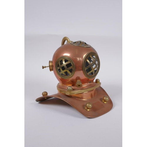 63 - A model copper and brass deep sea diver's helmet, 18cm high