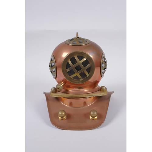 63 - A model copper and brass deep sea diver's helmet, 18cm high