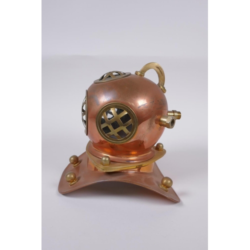 63 - A model copper and brass deep sea diver's helmet, 18cm high