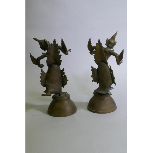 85 - A pair of Siamese bronze dancing figures, with inset glass eyes, and mirrored glass decoration, 29cm... 