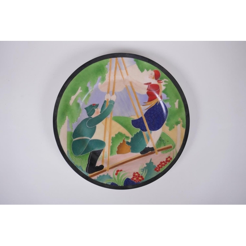 86 - A Soviet style porcelain cabinet plate decorated with a soldier and girl on a swing, 27cm diameter