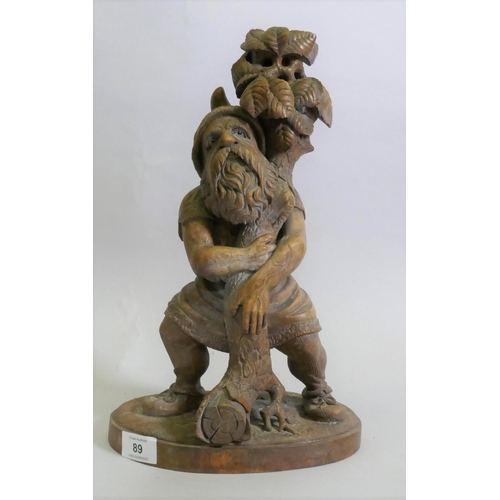 89 - A Black Forest carved wood gnome candleholder/stand, 36cm high