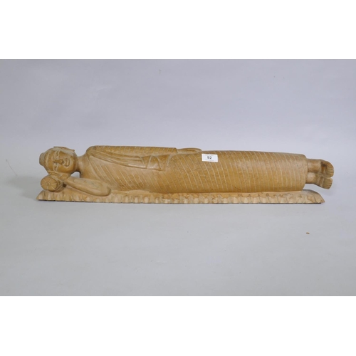 92 - A carved wood figure of sleeping Buddha, 72cm long