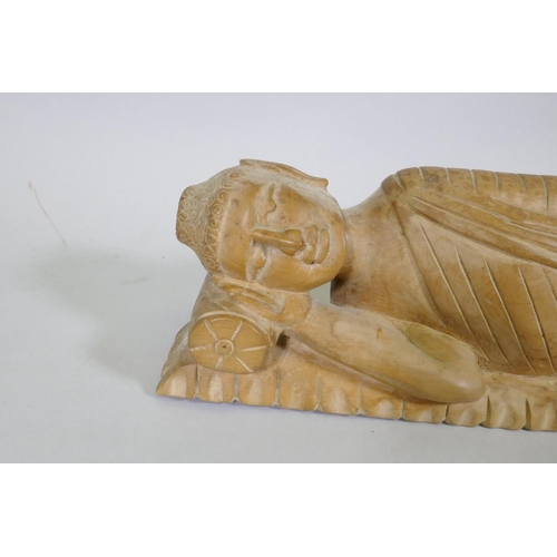 92 - A carved wood figure of sleeping Buddha, 72cm long