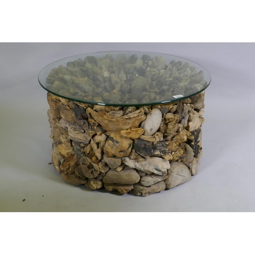 1132 - A driftwood glass topped coffee table, 74cm diameter, 40cm high